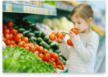 girl-smelling-tomato